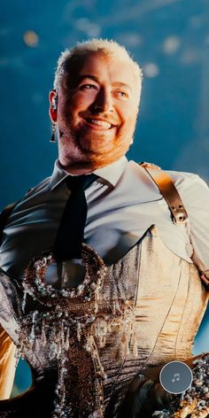 a man wearing a tie and suspenders is smiling