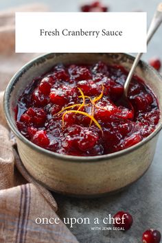 a bowl filled with cranberry sauce on top of a table