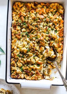 a casserole dish filled with stuffing and vegetables