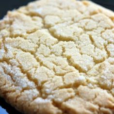 a close up view of a cookie on a black surface with white crumbs