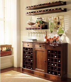 a wooden cabinet with wine glasses and bottles on it