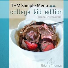 a bowl filled with chocolate and strawberries on top of a white cloth covered table