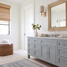 a bathroom with blue cabinets and white walls