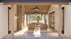 an outdoor living area with two chairs and a ceiling fan