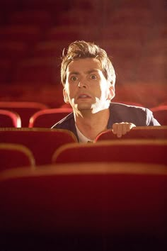 a man sitting in the middle of an empty theater