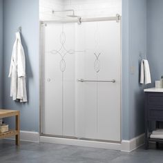 a bathroom with a walk in shower next to a sink