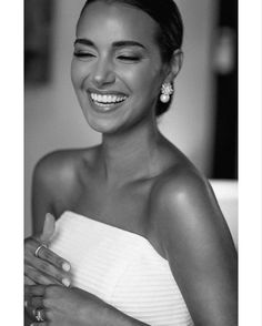 black and white photograph of a smiling woman in a towel with her hand on her shoulder