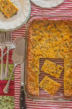 a casserole dish on a table with silverware and utensils