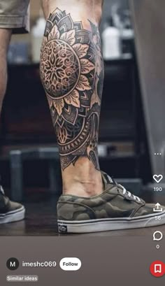 a man's leg with a tattoo on it, and his shoes are in the background