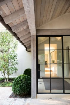 the entrance to a house with glass doors