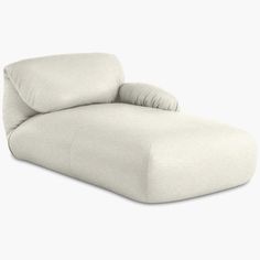 a white couch sitting on top of a white floor