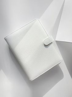 a white wallet sitting on top of a table