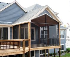 a house that is on the side of a hill with lots of windows and balconies