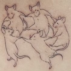 a drawing of cats and mice on the back of a woman's shoulder