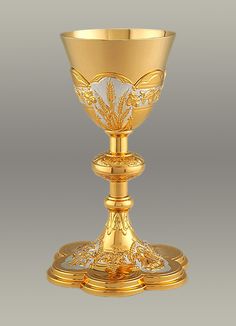 a golden chalice with an ornate design on the top and bottom, is shown