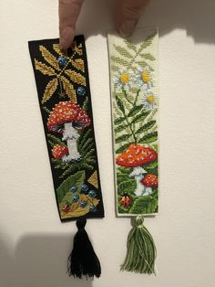 two cross stitch bookmarks one with mushrooms and the other with flowers