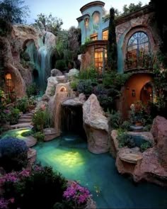 an outdoor waterfall in the middle of a garden