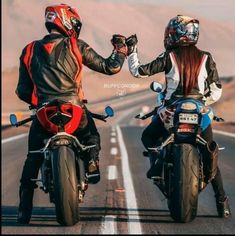 two people riding motorcycles on the road