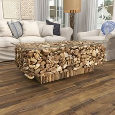 a coffee table made out of logs in a living room