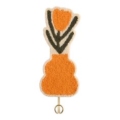 an orange and black flower on a hook