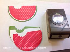 the paper is cut out to look like watermelon slices and other things are sitting next to it