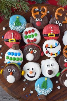 decorated cupcakes are arranged on a wooden platter