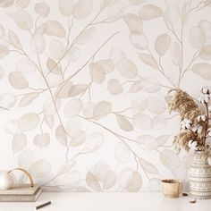 a vase filled with flowers sitting on top of a white table next to a wall