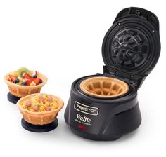 the waffle maker has two bowls of fruit in it and is ready to be eaten