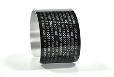 "Black Binary Computer Coding Image Aluminium Geekery Cuff Jewelry Technical Data: ■ Dimensions: 6.625\" x 1.625\" x .045\" ■ can be adjusted to fit almost any wrist size ■ ships in spiffy black velvet bag (classy!) The design is printed onto the surface of the aluminium using a triple-top secret process that permanently seals the image into the metal (actually the image is applied by the  process, but don't tell anyone, OK?). You don't have to worry if you are caught in the rain or get thrown i Coding Images, Aluminum Bracelets, Binary Code, Computer Programmer, Computer Coding, Cuff Jewelry, Geek Gifts, Discount Fabric, Geek Chic