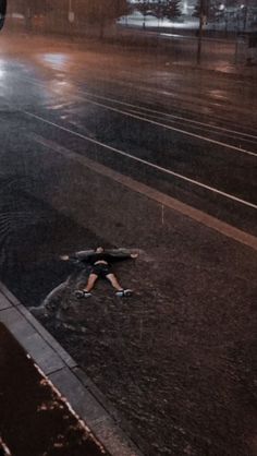 a person is walking down the street in the rain