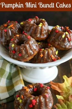 pumpkin mini bundt cakes with sprinkles in a white bowl on a table