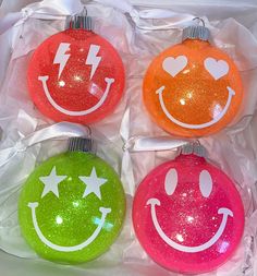 three christmas ornaments with smiley faces on them