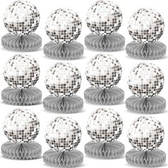 a bunch of disco balls sitting on top of each other in front of a white background