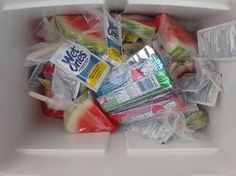 a white container filled with watermelon and popsicles