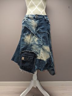 "Upcycled bleached denim patchwork skirt with frayed seams and jagged hem. Waist measures 36\" and length is approximately 22\"." Reconstructed Denim Skirt, Reworked Blue Denim Skirt, Summer Denim Reworked Skirt, Casual Reworked Medium Wash Denim Skirt, Blue Reworked Denim Skirt, Recycled Denim Patchwork Denim Skirt, Recycled Denim Patchwork Skirt, Denim Blue Patchwork Skirt From Recycled Denim, Medium Wash Cotton Skirt With Patchwork