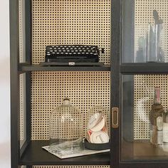 an old typewriter sits on top of a shelf