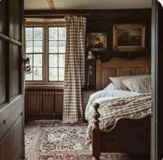 a bed sitting in a bedroom next to a window