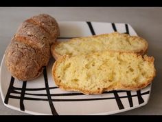 two loaves of bread on a plate with a black and white checkerboard pattern