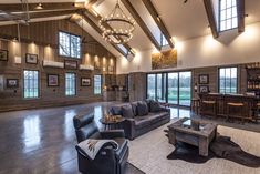 a large living room with high ceilings and wood paneling