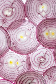 red onions are arranged in rows on top of each other, with one egg inside the middle