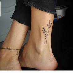 two people with tattoos on their feet and one has a flower tattoo on the ankle