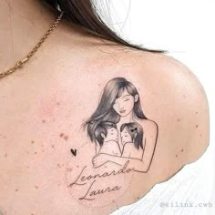 a woman with a tattoo on her shoulder holding a small dog and the words legend written in cursive writing