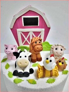 a cake with farm animals on it and a barn in the backgroung