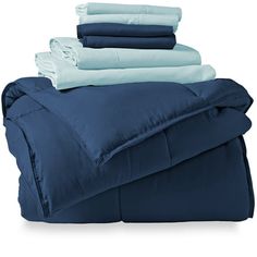 blue sheets and pillows stacked on top of each other