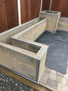 an unfinished concrete planter box sitting on the ground