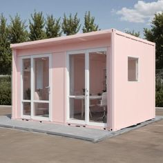 a pink portable office with sliding glass doors on the front and side, in a parking lot