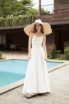 "The White Linen Halter Neck Midi Dress is a classic and timeless piece that belongs in every summer wardrobe. Made from high-quality linen fabric, this dress is lightweight, breathable, and perfect for hot and humid weather. The halter neck design of the dress adds a touch of sophistication and elegance to the overall look. The neckline sits high on the collarbone, providing coverage and support while still showcasing the shoulders and arms. The midi length of the dress falls just below the kne Classic Cotton Midi Dress For Summer, Classic Summer Midi Dress For Day Out, Classic Summer Day Dress, Classic Summer Maxi Dress, Classic Summer Daywear Dress, Classic Beach Dresses For Spring, Summer A-line Maxi Dress For Daywear, Classic Spring Dress For Vacation, Classic Summer Midi Dress For Brunch