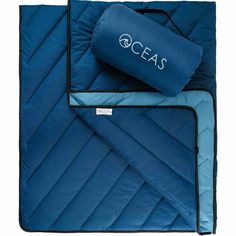 an ocean blanket and pillow set with the word seas on it in white lettering, sitting next to each other