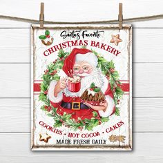 an old fashioned christmas baking sign hanging on a clothes line with the words cookies, hot cocoa and cake