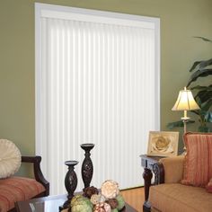 a living room with two couches and a sliding glass door